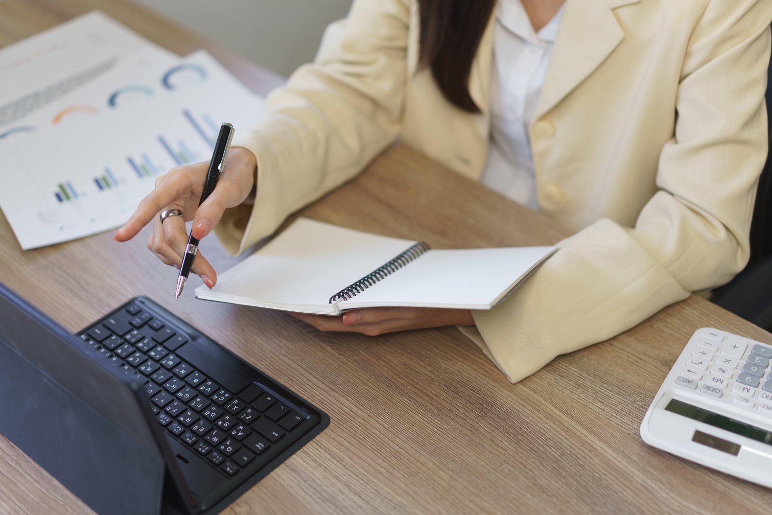 Secretary concept, Female secretary pointing business data on ta